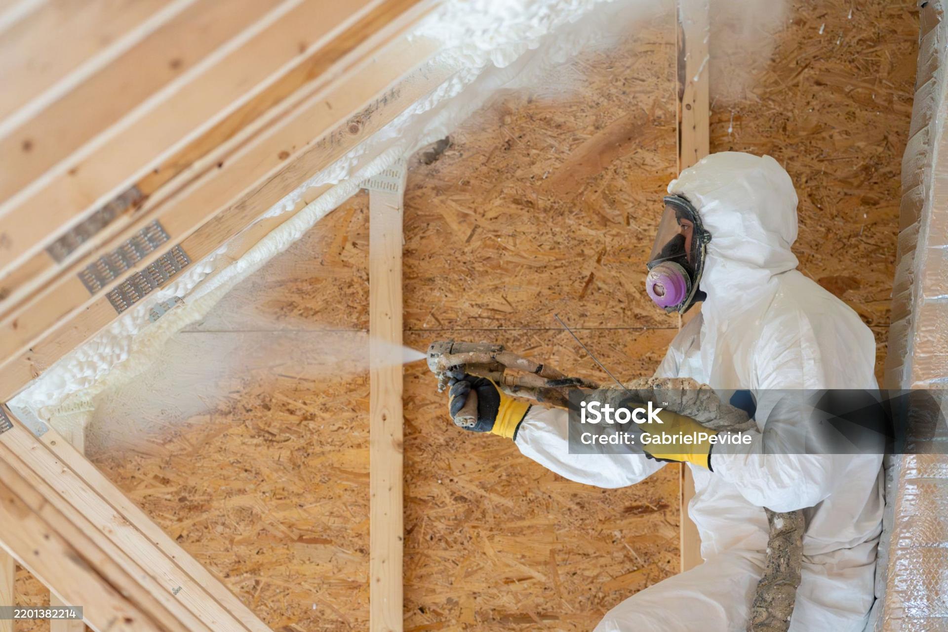 Professional applicator spraying foam insulation